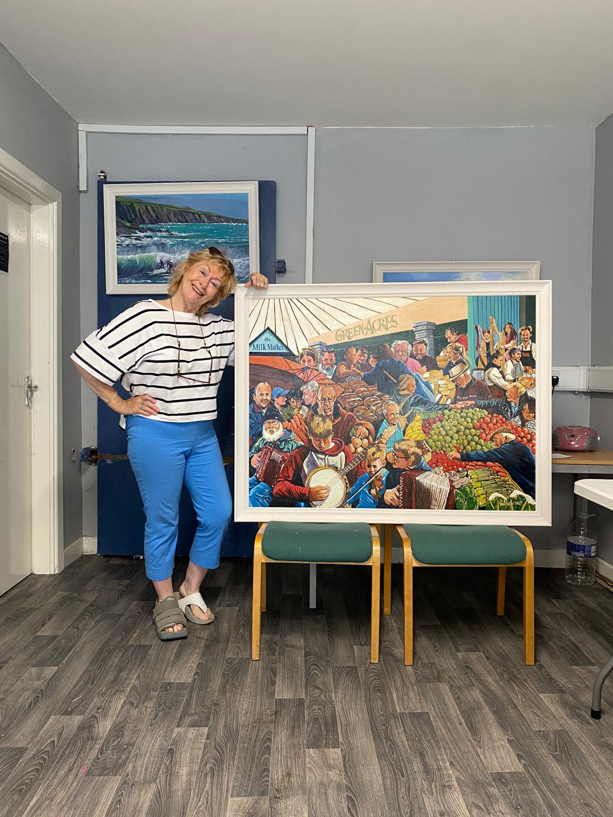 Artist Una Heaton with the framed original Milk Market painting